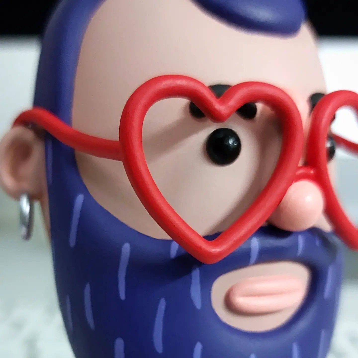 Close-up of the painted face and heart-shaped glasses