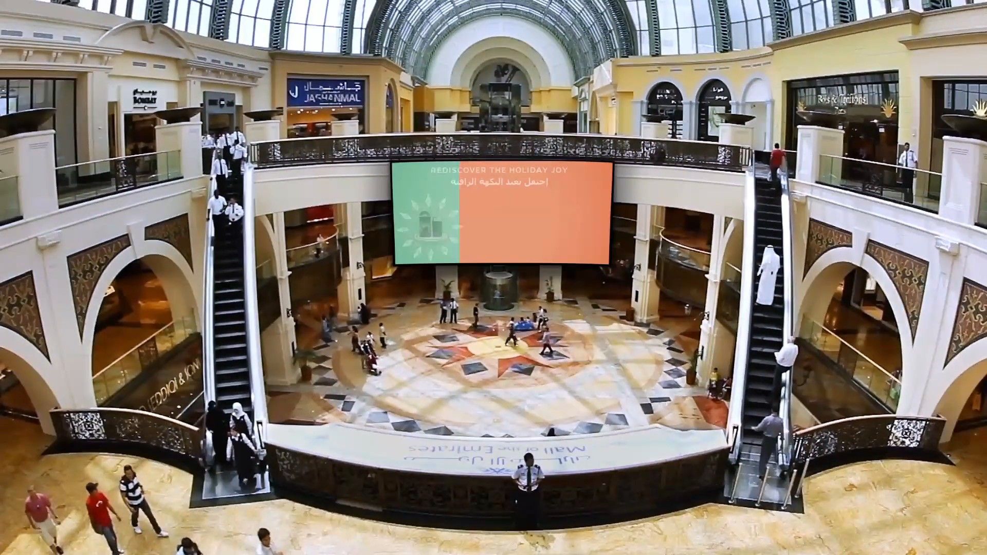 Giant screen in the Dubai Mall atrium showing the Nespresso campaign
