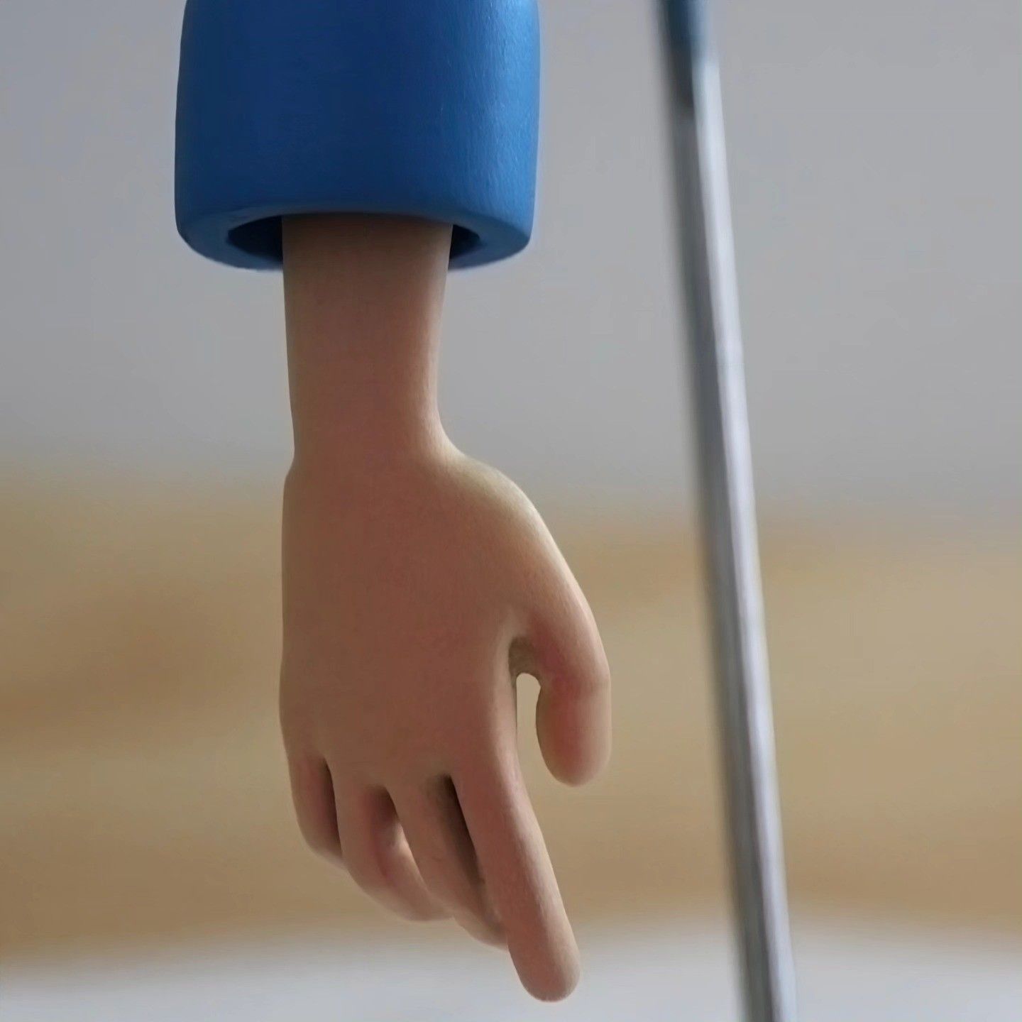 Detail of the hand hanging from the sleeve