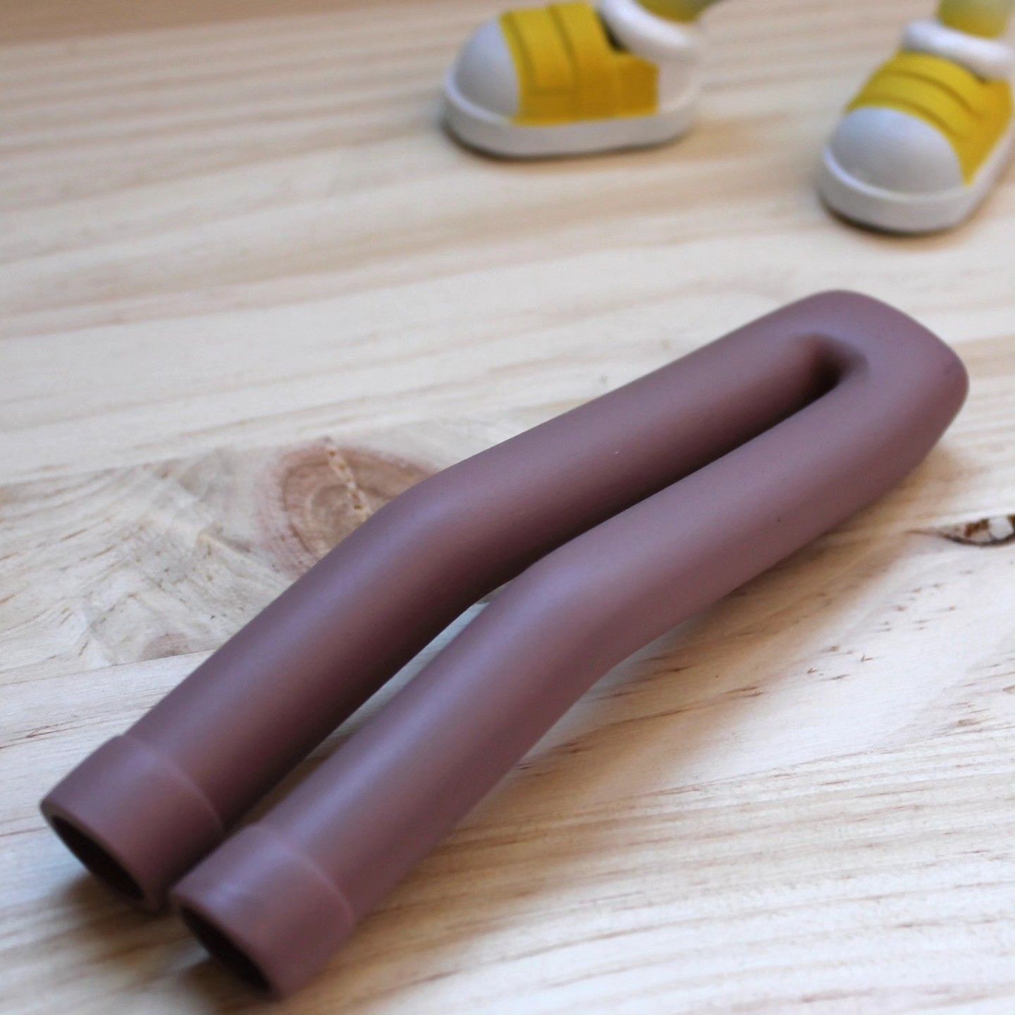 The long brown legs lying on a wooden table before assembly